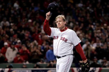 Curt Schilling poses a picture while fans are respecting him on the pitch.